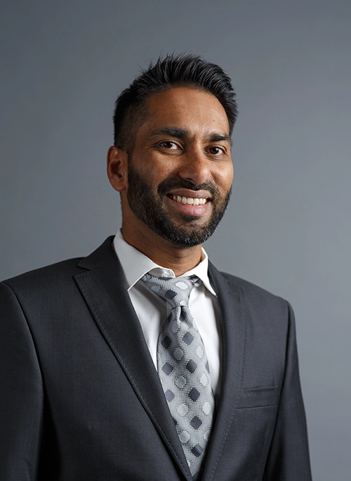 Dr Faizel Mansoor Suit grey background
